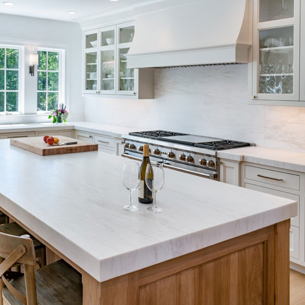 Porcelain countertop and backsplash in white kitchen