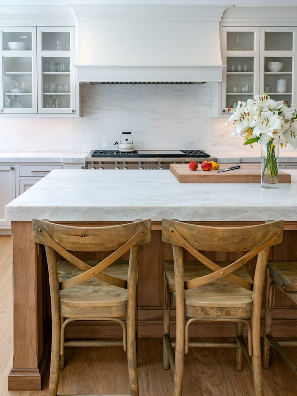 Porcelain countertop and backsplash in white kitchen