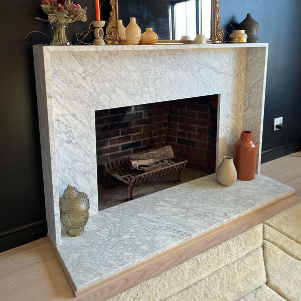 Custom stone fireplace against a black wall